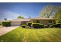 Inviting single story home with landscaped front yard and basketball hoop by the attached garage at 7285 E County Road 900 N, Brownsburg, IN 46112