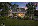 Charming home at dusk with professionally landscaped front yard at 744 Gilbert Ave, Indianapolis, IN 46227