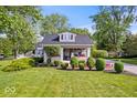 Well-maintained home featuring a welcoming front porch and manicured lawn at 744 Gilbert Ave, Indianapolis, IN 46227