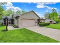 Attractive single-story home with attached garage, screened in porch and well-maintained landscaping at 7655 N Kitchen Rd, Mooresville, IN 46158
