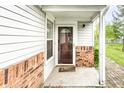 Inviting covered front porch with brick accents and well-maintained front door at 7703 Park North Lake Dr, Indianapolis, IN 46260