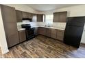 Modern kitchen with new appliances, countertops, wood flooring, and ample cabinet space at 810 S 18 Th St, Elwood, IN 46036