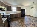 Well-lit kitchen featuring new appliances and plenty of cabinet space with dark wood flooring at 810 S 18 Th St, Elwood, IN 46036