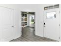 A bright entryway with wood-look floors leading to the open-concept living space at 89 Kinnick Dr, Greenwood, IN 46143