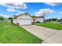 Image highlighting the home's front lawn and a long driveway leading up to the two-car garage at 917 Congressional Way, Shelbyville, IN 46176