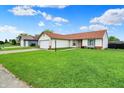View of the house from the street showcasing the spacious front lawn and two-car garage at 917 Congressional Way, Shelbyville, IN 46176