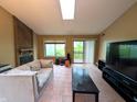 Bright living room featuring a cozy fireplace and sliding glass door to a private patio at 93 Lookout Ridge Dr # 24U, Columbus, IN 47201