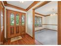 The foyer welcomes you with wood trim, hardwood floors, and a bright view into the living area at 101 Applecross Dr, Brownsburg, IN 46112