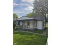 Inviting one-story house featuring a covered front porch and freshly cut grass at 114 S Catherwood Ave, Indianapolis, IN 46219