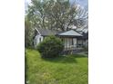 Attractive single-level home with decorative iron porch supports and mature landscaping at 114 S Catherwood Ave, Indianapolis, IN 46219