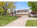 Two-story home with attached garage, mature trees and a well-maintained lawn at 1242 W Huntsville Rd, Pendleton, IN 46064
