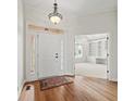 Bright foyer with hardwood floors, white trim, and entry to office at 12739 Kiawah Dr, Carmel, IN 46033