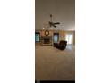 Spacious living room with a brick fireplace, plush carpet, and sliding glass doors to the backyard at 12974 Shandon Ln, Fishers, IN 46038