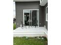 White back porch with a glass sliding door and a table with chairs at 1327 Union St, Columbus, IN 47201