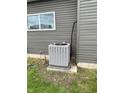 Air conditioning unit located on the side of the home. Gray siding at 1327 Union St, Columbus, IN 47201