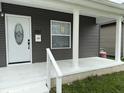 Charming home's front porch with a bright white door and updated siding at 1327 Union St, Columbus, IN 47201