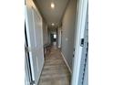 Long hallway featuring wood-look floors and neutral gray walls at 1380 Fairmount Dr, Greenfield, IN 46140
