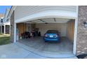 Spacious two-car garage with ample storage space and a blue car parked inside at 142 Winding Brook Way, Pendleton, IN 46064
