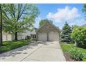 Front exterior of home featuring a two-car garage and driveway at 14634 Village Park East Dr, Carmel, IN 46033