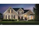 Beautiful brick and stone home with a manicured lawn and decorative shrubbery at 14707 Thor Run Dr, Fishers, IN 46040