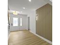 Bright entryway featuring hardwood floors, a decorative wall, and a staircase at 16 Maplecrest Dr, Carmel, IN 46033