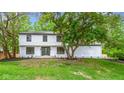 Front exterior of home with large front yard and big tree in the front at 16 Maplecrest Dr, Carmel, IN 46033
