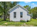 Exterior shot with green lawns, and a two windows allowing natural light at 1610 S F St, Elwood, IN 46036
