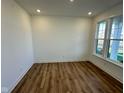 Bright empty room with recessed lights and vinyl floor plus a large window overlooking the yard at 1679 W 171St St, Westfield, IN 46074