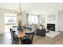Bright living room with wood floors, modern light fixture, and comfortable gray sofa near a fireplace at 175 Rock Island Rd, Westfield, IN 46074