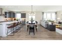 Bright open-concept living area with kitchen, dining space, and comfortable seating near large windows at 175 Rock Island Rd, Westfield, IN 46074