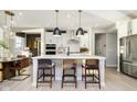 Beautiful kitchen with a large center island, pendant lights, and modern appliances at 18943 Seaforth Way, Westfield, IN 46074