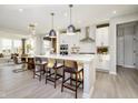 Bright, open kitchen with a center island, stainless steel appliances, and pendant lighting at 18943 Seaforth Way, Westfield, IN 46074