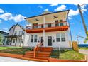 Inviting two-story duplex with a cozy shared porch and well-maintained lawn at 2013 Yandes St, Indianapolis, IN 46202