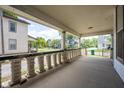 View of the porch and neighborhood with detailed columns, offering an outdoor space at 207 S Center St, Plainfield, IN 46168