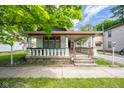 Inviting porch features classic columns, offering a relaxing outdoor space at 207 S Center St, Plainfield, IN 46168