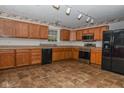Functional kitchen with wooden cabinets, modern appliances, and neutral flooring offering a comfortable cooking space at 2416 Foxtail Dr, Plainfield, IN 46168