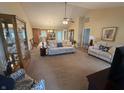 Spacious living room with neutral tones, vaulted ceilings, and open layout flowing into the kitchen at 2635 Red Admiral Ln, Lebanon, IN 46052
