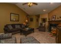 Well-lit living room featuring a fireplace, plush seating, and neutral-toned carpet at 270 Rapid Rill Ln, Brownsburg, IN 46112