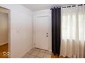 Inviting foyer with tiled floors and ample natural light streaming through the window at 3510 E 34Th St, Indianapolis, IN 46218
