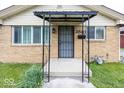 Close up of the covered front porch featuring a security door and house number at 3510 E 34Th St, Indianapolis, IN 46218