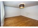 Bright living room featuring hardwood floors and a stylish light fixture at 3510 E 34Th St, Indianapolis, IN 46218
