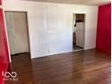 Bright living room with hardwood floors and a glimpse into the adjacent kitchen area at 3528 Orchard Ave, Indianapolis, IN 46218