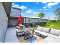 Cozy outdoor patio featuring comfortable seating, a picnic table, and a colorful rug at 3682 S 380 E, Anderson, IN 46017