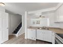 Bright kitchen featuring white cabinetry, stainless steel appliances, and a view of stairs and the living room at 3705 Lima Ct, Indianapolis, IN 46227