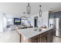 Modern kitchen with stainless steel appliances, a large island, and open to the living room at 379 N Post Oak Dr, Mooresville, IN 46158