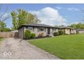 Exterior shot of renovated house including new landscaping and expansive front lawn at 4337 N Audubon Rd, Indianapolis, IN 46226