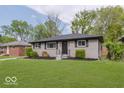 Charming home exterior featuring updated landscaping, freshly cut lawn, and a neatly manicured front yard at 4337 N Audubon Rd, Indianapolis, IN 46226