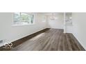 Bright, open-concept living area with hardwood floors and a view into the modern kitchen at 4337 N Audubon Rd, Indianapolis, IN 46226