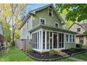 Inviting home showcasing a screened-in porch and manicured garden beds at 4447 N College Ave, Indianapolis, IN 46205