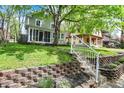 Landscaped front yard with brick retaining wall and steps leading to home's entrance at 4447 N College Ave, Indianapolis, IN 46205